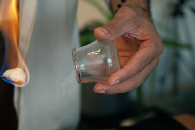 Close-up of man holding glas