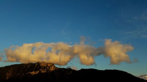 Scenic view of mountains against blue sky