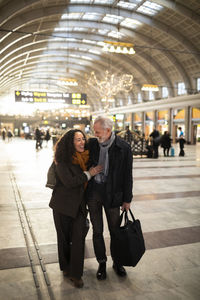 Happy couple at train station