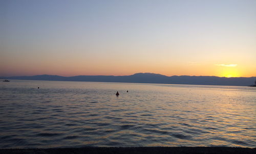 Scenic view of sea against clear sky during sunset