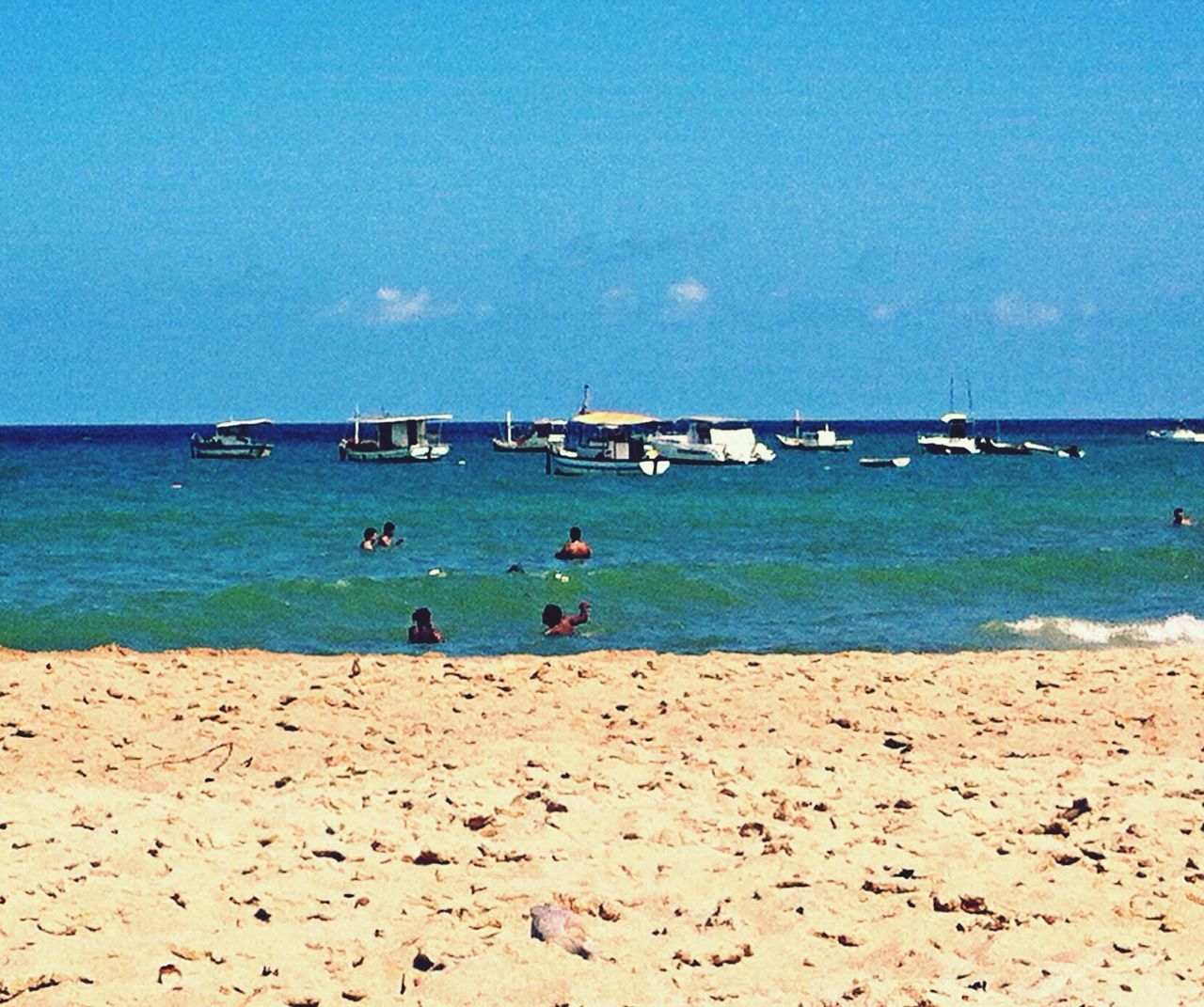 water, sea, beach, nautical vessel, transportation, mode of transport, shore, lifestyles, boat, leisure activity, sand, horizon over water, blue, vacations, men, sky, tranquility, nature, tranquil scene