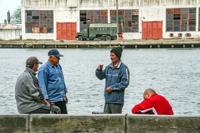 Men sitting on boat in river