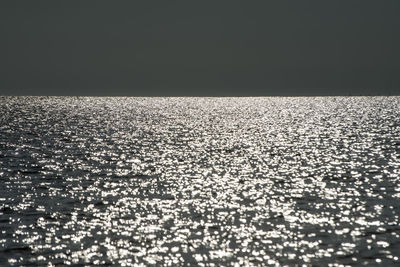 Surface level of sea against clear sky