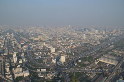 High angle view of illuminated city buildings against sky