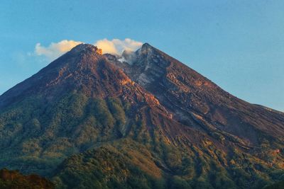 Low angle view of volcanic mountain against sky