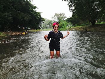 Woman splashing water in river