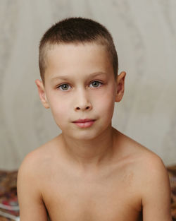 Portrait of a seven-year-old boy without a shirt with a short haircut