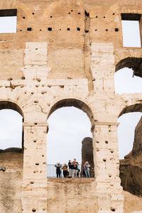Colosseum detail arch with tourists 