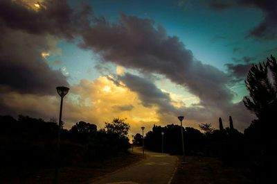 View of road against cloudy sky at dusk