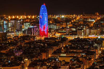 High angle view of illuminated buildings in city at night, barcelona,torre glories