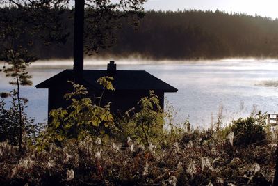 Built structure on shore by lake