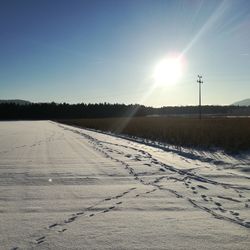 Scenic view of snowy field against clear sky