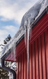 Low angle view of icicles against sky