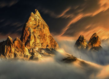 Panoramic view of rock formation on land against sky during sunset