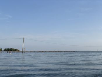 Bridge over sea against sky