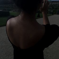 Portrait of young woman standing on tiled floor