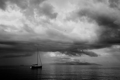 Sailboat in sea against sky