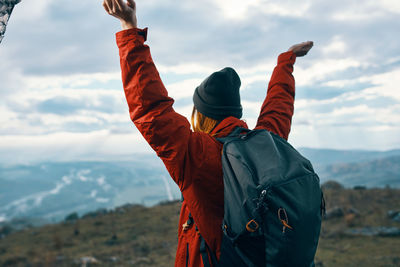 Midsection of man standing on mountain against sky