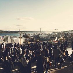 People on street in city against sky