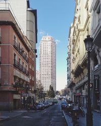 City street amidst buildings against sky