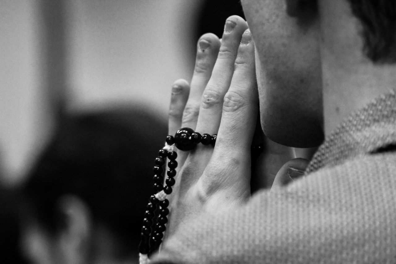 hand, one person, human hand, jewelry, human body part, real people, indoors, women, focus on foreground, close-up, adult, body part, lifestyles, bracelet, leisure activity, bead, midsection, selective focus, religion, finger, personal accessory