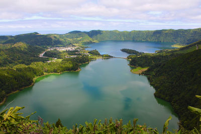 Scenic view of lake and mountains against sky