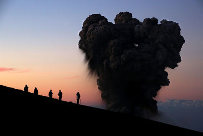 Low angle view of silhouette people against clear sky during sunset