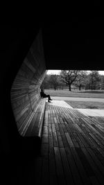 Sitted man on a wooden bench