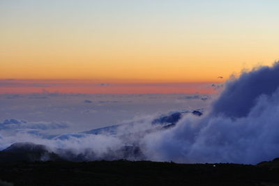 Scenic view of mountains against sky at sunset