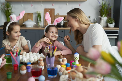 Mother playing with daughters at home