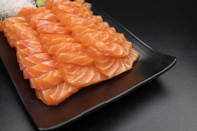 High angle view of chopped fish in plate on table