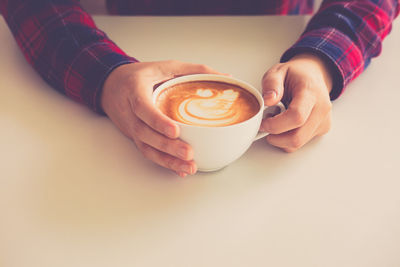 Close-up of coffee cup with heart shape