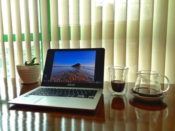 Glass of laptop on table