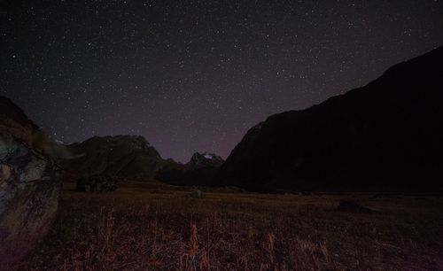 Scenic view of landscape against sky at night