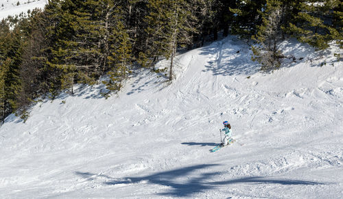 Aerial view of woman skiing on snowcapped mountain