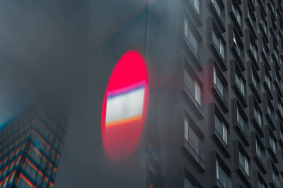 Low angle view of buildings red light on building 