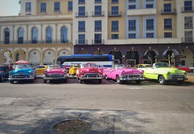 Cars on street against buildings in city