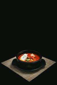 Close-up of soup in bowl against black background