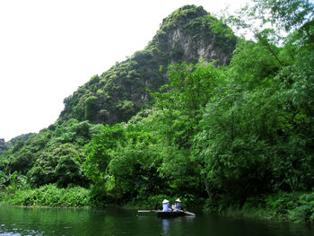 Scenic view of lake by trees against sky