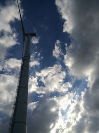 Low angle view of windmill against cloudy sky
