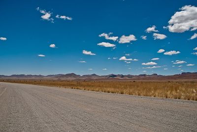 Scenic view of landscape against blue sky