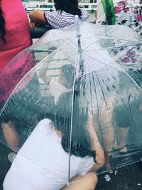 Low section of person with reflection on glass