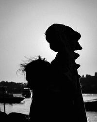 Silhouette person on beach against clear sky