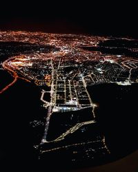 Aerial view of illuminated city at night