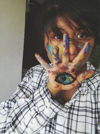 Close-up of woman with messy face at home