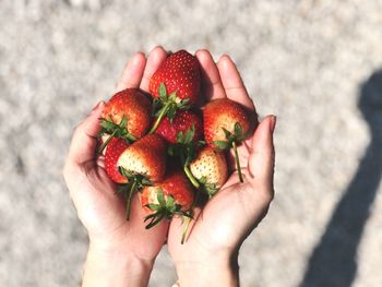 Cropped hands holding strawberries