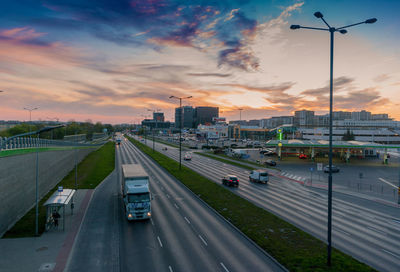 High angle view of cars on street against sky during sunset