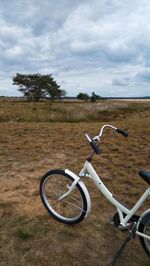 Bicycle on field against sky