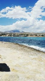 View of beach against cloudy sky