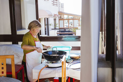 Senior woman preparing spanish christmas pastry pestinos